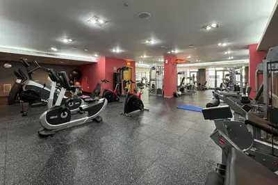 a gym with several treadmills and exercise bikes at Downtown Luxury 1 Bed with City Skyline Views in Dubai