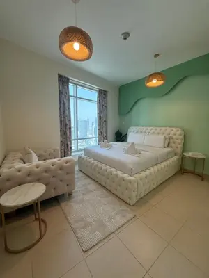 a bedroom with a large bed and a couch at Serene Cozy 2BR Near Burj Khalifa in Dubai