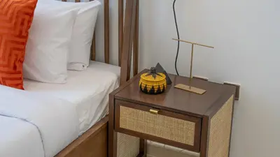 a bedroom with a bed and a nightstand with a pineapple on it at Cityscape & Coastal Charm Elegant 2BR Seaside in Dubai Marina