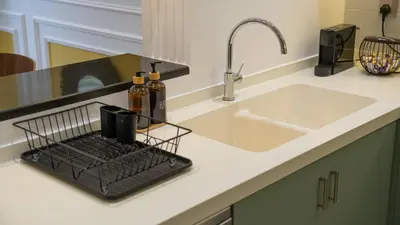 a kitchen counter with a sink and a sink at Cityscape & Coastal Charm Elegant 2BR Seaside in Dubai Marina