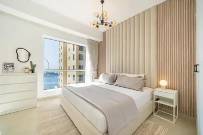 a bedroom with a large bed and a window at High-Floor 1BR New Design Steps to JBR Beach in Dubai