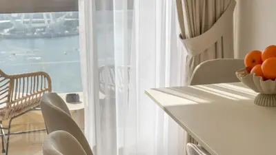 a table and chairs with a bowl of oranges on it at High-Floor 1BR New Design Steps to JBR Beach in Dubai