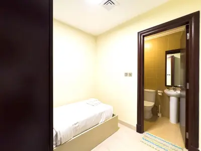 a bathroom with a bed and a toilet at Luxury 2BR plus Maidrm at Grandeur Res Palm Jumeir in Dubai