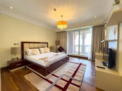 a bedroom with a bed and a television in it at Luxury 2BR plus Maidrm at Grandeur Res Palm Jumeir in Dubai