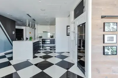 a kitchen with a black and white checkered floor at 65th Floor Penthouse Dubai Marina in Dubai