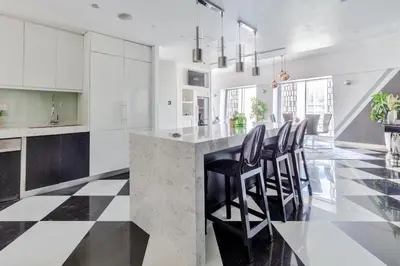 a kitchen with a black and white checkered floor at 65th Floor Penthouse Dubai Marina in Dubai