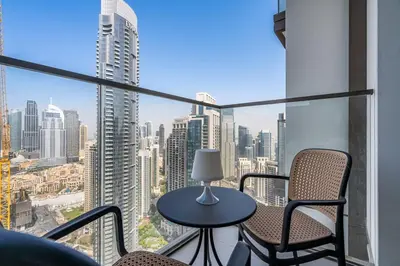 a balcony with chairs and a table and a view of a city at Venetian - Wake up to Burj Khalifa views in Downtown Dubai in Dubai