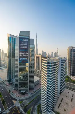 a group of tall buildings in a city at Venetian - Luxe Living 1 BR with Stunning Sky Line Views in Dubai