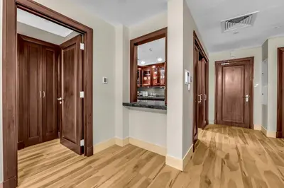 an empty room with wooden doors and wooden floors at Front Burj Khalifa 2BR in Old town community in Dubai