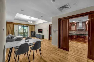 a living room and dining room with a table and chairs at Front Burj Khalifa 2BR in Old town community in Dubai