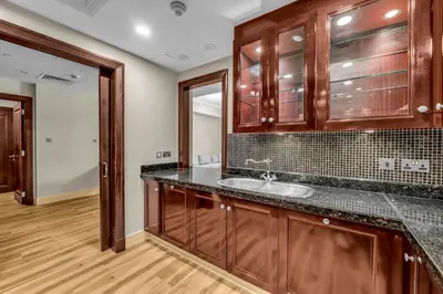 a bathroom with a sink and wooden cabinets at Front Burj Khalifa 2BR in Old town community in Dubai