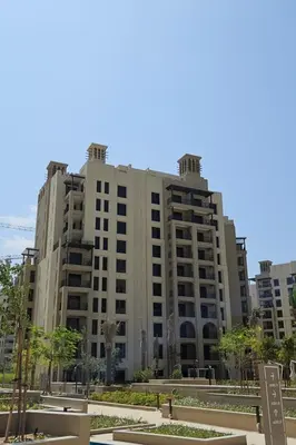 a large apartment building with a park in front of it at HAVN - 1 Bedroom in Madinat Jumeirah Living in Dubai