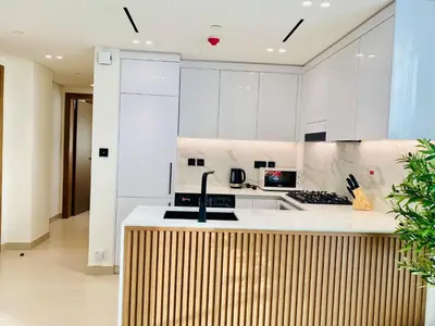 a kitchen with white cabinets and a counter top at Modern & Cozy 1 Bedroom Apartment in JVC 215-GLX-1 in Dubai