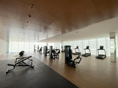 a gym with many exercise equipment in a building at Modern & Cozy 1 Bedroom Apartment in JVC 215-GLX-1 in Dubai