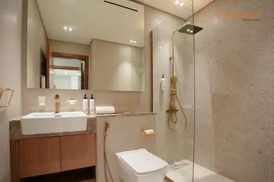 a bathroom with a shower and a toilet and a sink at Bnbeyond's Chic Urban Retreat with Upscale 1BR in Dubai