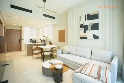 a living room with a couch and a table at Bnbeyond's Chic Urban Retreat with Upscale 1BR in Dubai
