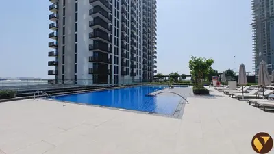 a swimming pool in the middle of a building at Vogue Creek Harbour Creek Crescent Waterfront Living Close to Downtown, Burj Khalifa and Dubai Mall, One Bedroom Apartment with Balcony and City View, Access to all Amenities in Dubai