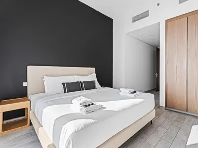 a bedroom with a large bed with two phones on it at Chic City Escape - 2BR Plus Guest Room at Atria, Business Bay in Dubai