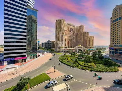 a city with tall buildings and cars on a street at Fully Furnished Studio at Spring Oasis in Dubai Silicon Oasis in Dubai