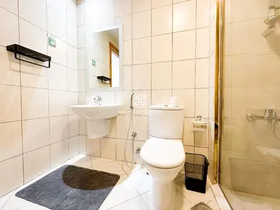 a bathroom with a toilet and a sink and a shower at Fully Furnished Studio at Spring Oasis in Dubai Silicon Oasis in Dubai
