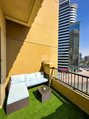 a balcony with a couch on the side of a building at Fully Furnished Studio at Spring Oasis in Dubai Silicon Oasis in Dubai