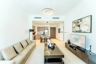 a living room with a couch and a table at FAM Living Act Two 1BR Walk to Burj & Dubai Mall in Dubai