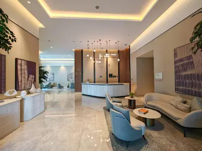 a lobby of a hotel with couches and chairs at FAM Living Act Two 1BR Walk to Burj & Dubai Mall in Dubai