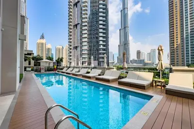 a pool on the roof of a building at FAM Living Act Two 1BR Walk to Burj & Dubai Mall in Dubai