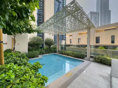 a swimming pool in the middle of a building at FAM Living Act Two 1BR Walk to Burj & Dubai Mall in Dubai