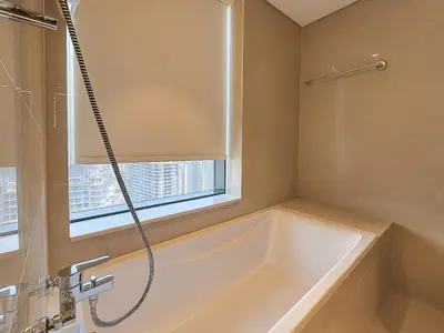 a bathroom with a bath tub and a window at Dream Shoma Upscale 3BR in Downtown Dubai in Dubai