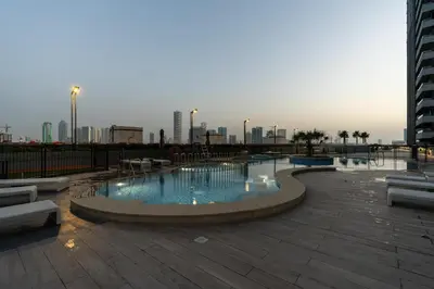 a large swimming pool with a city in the background at BLVD - Upgraded Highrise Suites in Dubai