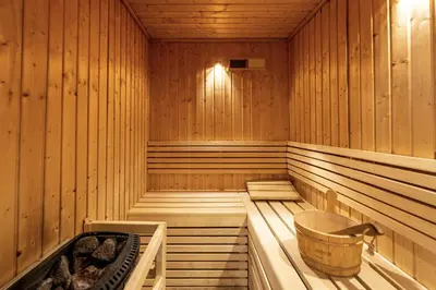 a sauna with a tub and a basket in it at BLVD - Upgraded Highrise Suites in Dubai