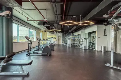 a gym with several treadmills and cardio machines at Luxury unit in the Heart of Dubai Hills in Dubai