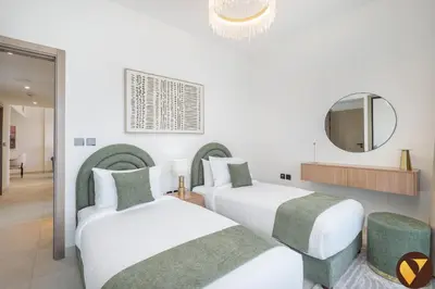 a hotel room with two beds and a mirror at Vogue Al Jadaf Binghatti Creek near Festival Mall, Three Bedroom Apartment with Balcony and City View, Access to all Amenities in Dubai
