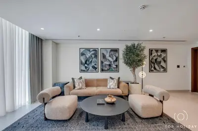 a living room with a couch and chairs and a table at Romantic basic apertmen in Dubai