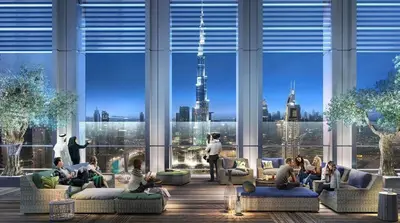a group of people sitting in a large room with large windows at Dreamy Apartment,Pool with Burj khalifa View ,5Min Walk to Dubai Mall in Dubai