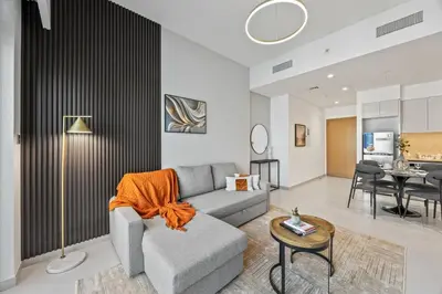a living room with a couch and a table at Dreamy Apartment,Pool with Burj khalifa View ,5Min Walk to Dubai Mall in Dubai
