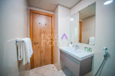 a bathroom with a sink and a mirror at Stylish 2BR in Continental Tower Dubai Marina in Dubai