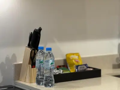 two bottles of water sitting on top of a counter at Cozy Studio with Balcony Pool View - Business Bay in Dubai