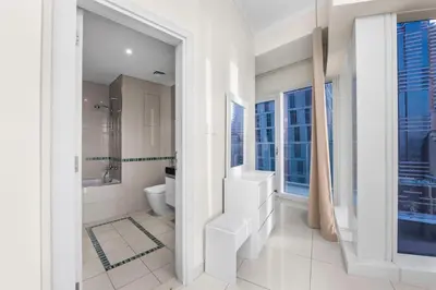 a white bathroom with a toilet and a sink at Luxury Apartment 2BR with Sea & Palm View - DAMAC Heights in Dubai
