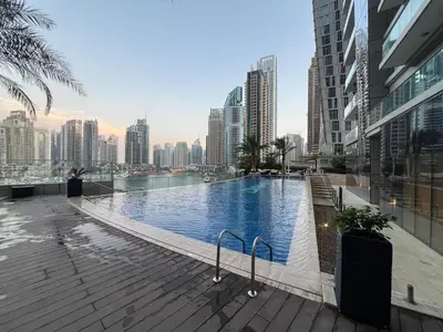 a swimming pool in the middle of a city with tall buildings at Luxury Apartment 2BR with Sea & Palm View - DAMAC Heights in Dubai