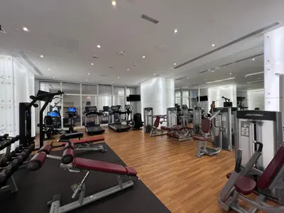 a gym with a lot of treadmills and machines at Luxury Apartment 2BR with Sea & Palm View - DAMAC Heights in Dubai