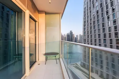 a balcony with a table and a view of a city at Luxury Apartment 2BR with Sea & Palm View - DAMAC Heights in Dubai