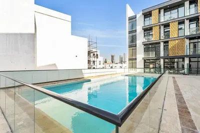 a swimming pool on the roof of a building at DAYF-SER08 Brand New Studio with Balcony in JVC in Dubai