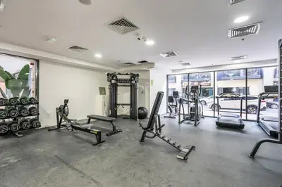 a gym with several treadmills and machines in it at DAYF-SER08 Brand New Studio with Balcony in JVC in Dubai