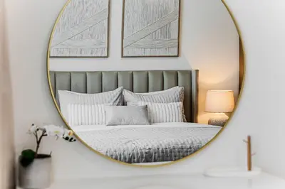 a mirror above a bed in a bedroom at 1BD Apartment at Creek Beach with Lagoon Access in Dubai
