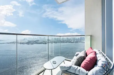 a balcony with a couch and a view of the water at Stunning Home with Creek and Downtown Views in Dubai