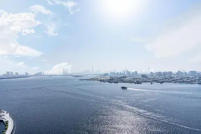 a boat in the water with a city in the background at Stunning Home with Creek and Downtown Views in Dubai