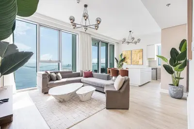 a living room with a couch and a table at Stunning Home with Creek and Downtown Views in Dubai