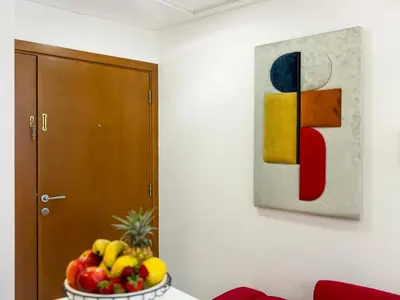 a bowl of fruit in a room with a painting at Amazing Design Colorfull Flat Palm Jumeirah View in Heart of Marina in Dubai
